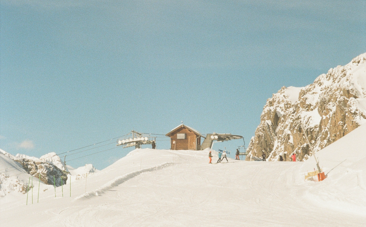 Mountain ski slope with skiers and ski lift
